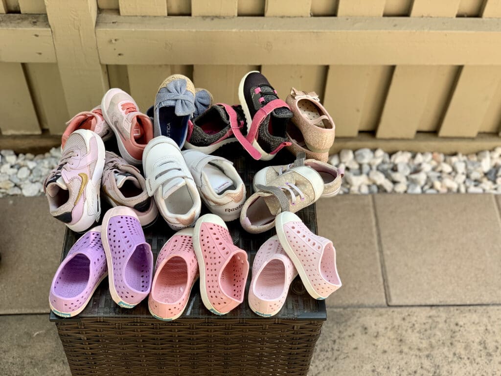 a collection of our little one's shoes